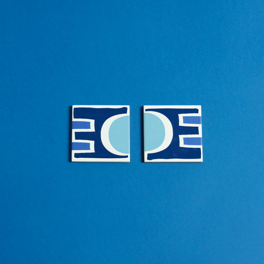 Porcelain coasters with abstract geometric shapes in a bold color palette.