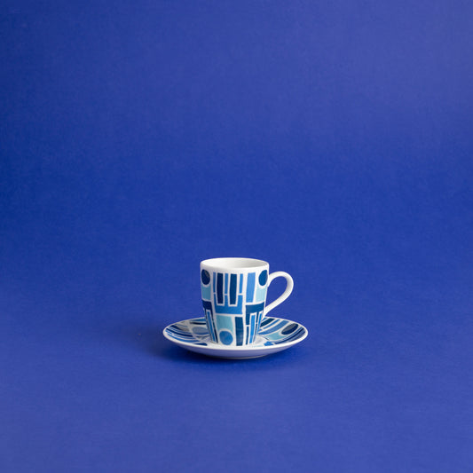 Porcelain espresso cup with saucer with abstract geometric shapes in a bold color palette.